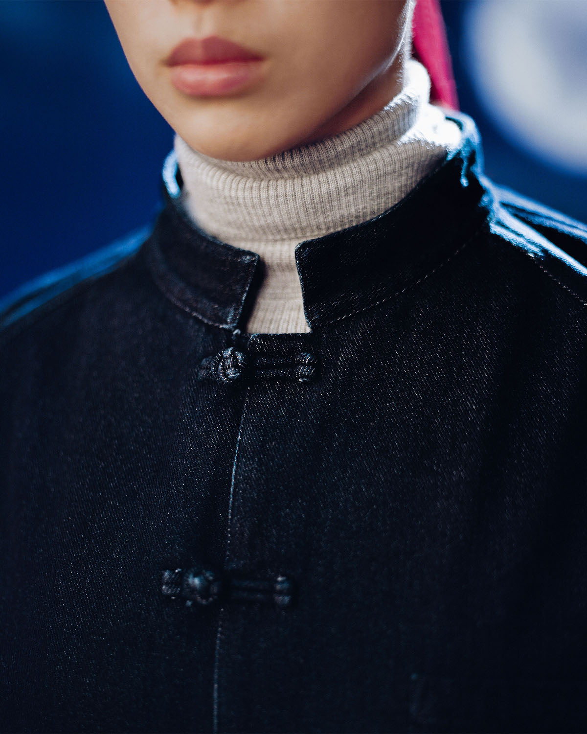 A person wearing the DENIM CHORE JACKET by Sundae School.