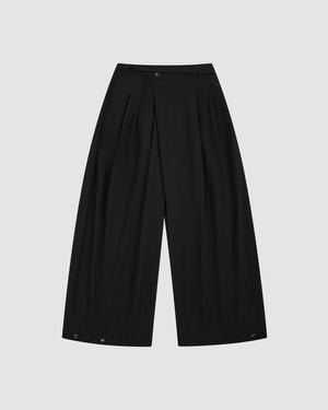 Sundae School Black Pleated Nylon Pants featuring wide-leg silhouette with front pleats, asymmetric fly with D-ring belt, and elastic waistband on light background