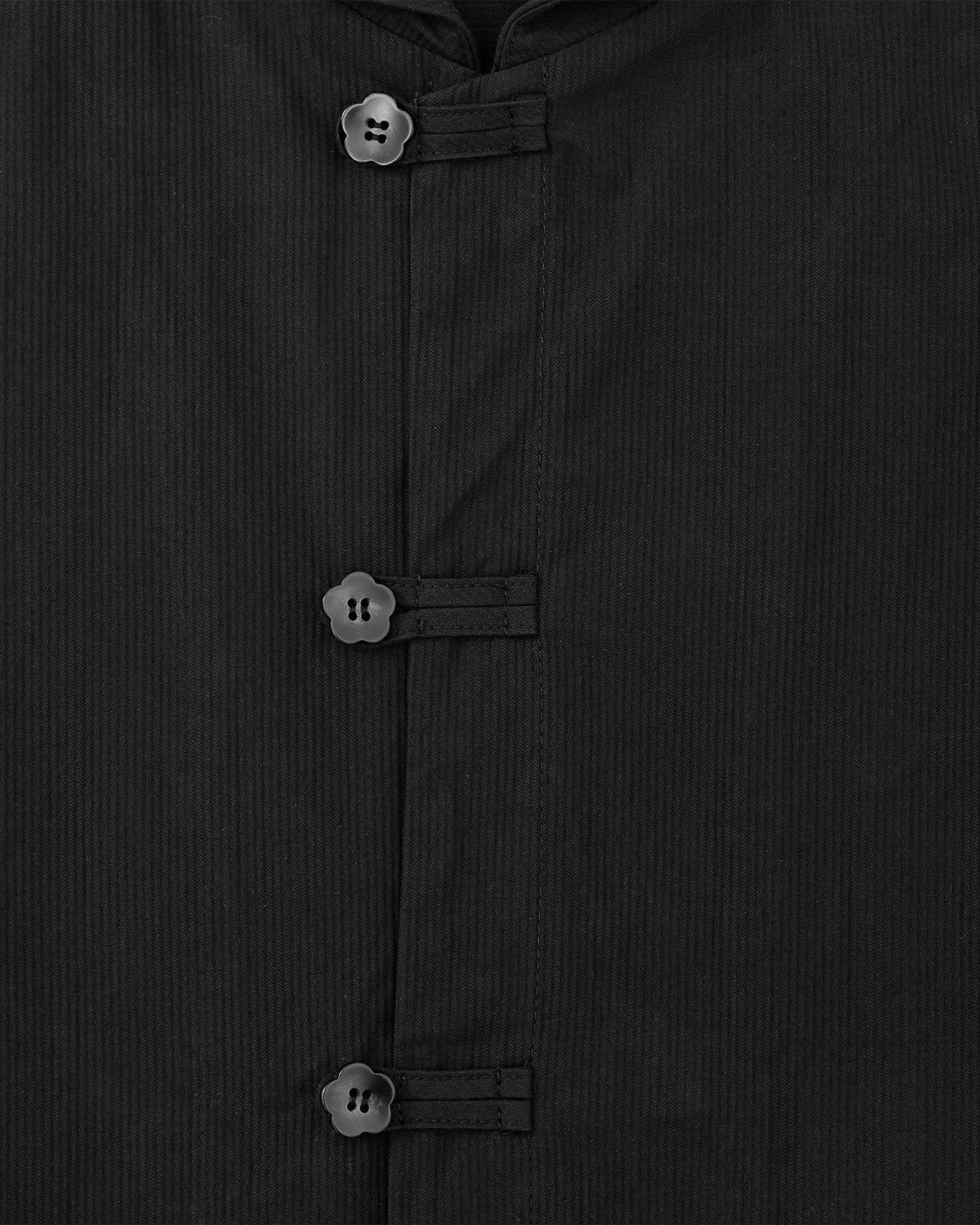 Close-up of the BLACK CHINA COLLAR KNOT SHACKET by Sundae School, featuring three black frog buttons arranged vertically on the front and a subtle pinstripe textured fabric.