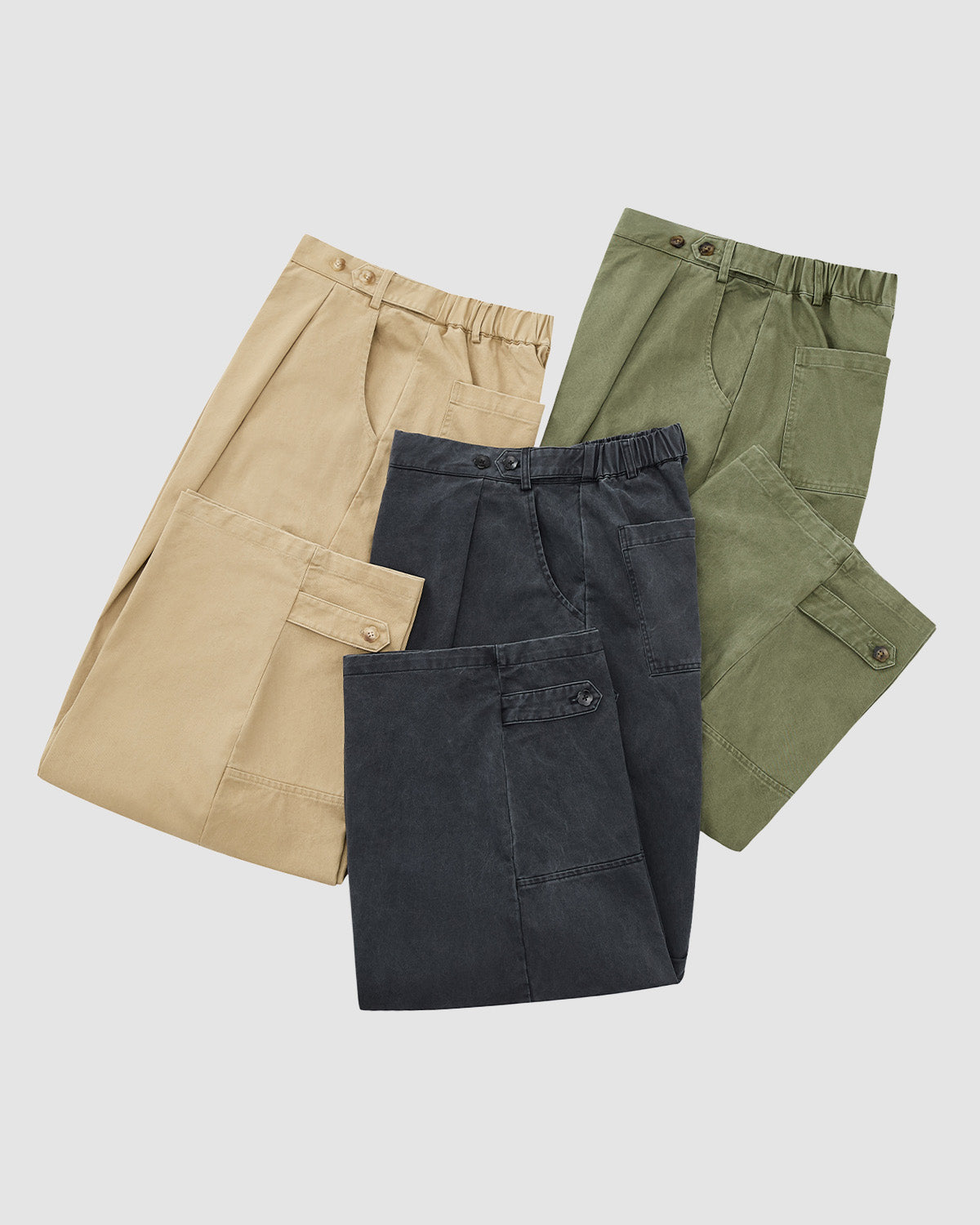 Three pairs of Sundae School CHARCOAL HANBOK CHINO PANTS with elastic waists in beige, dark gray, and olive green are laid flat. These barrel-fit pants feature front and back pockets and a hanbok-inspired silhouette.