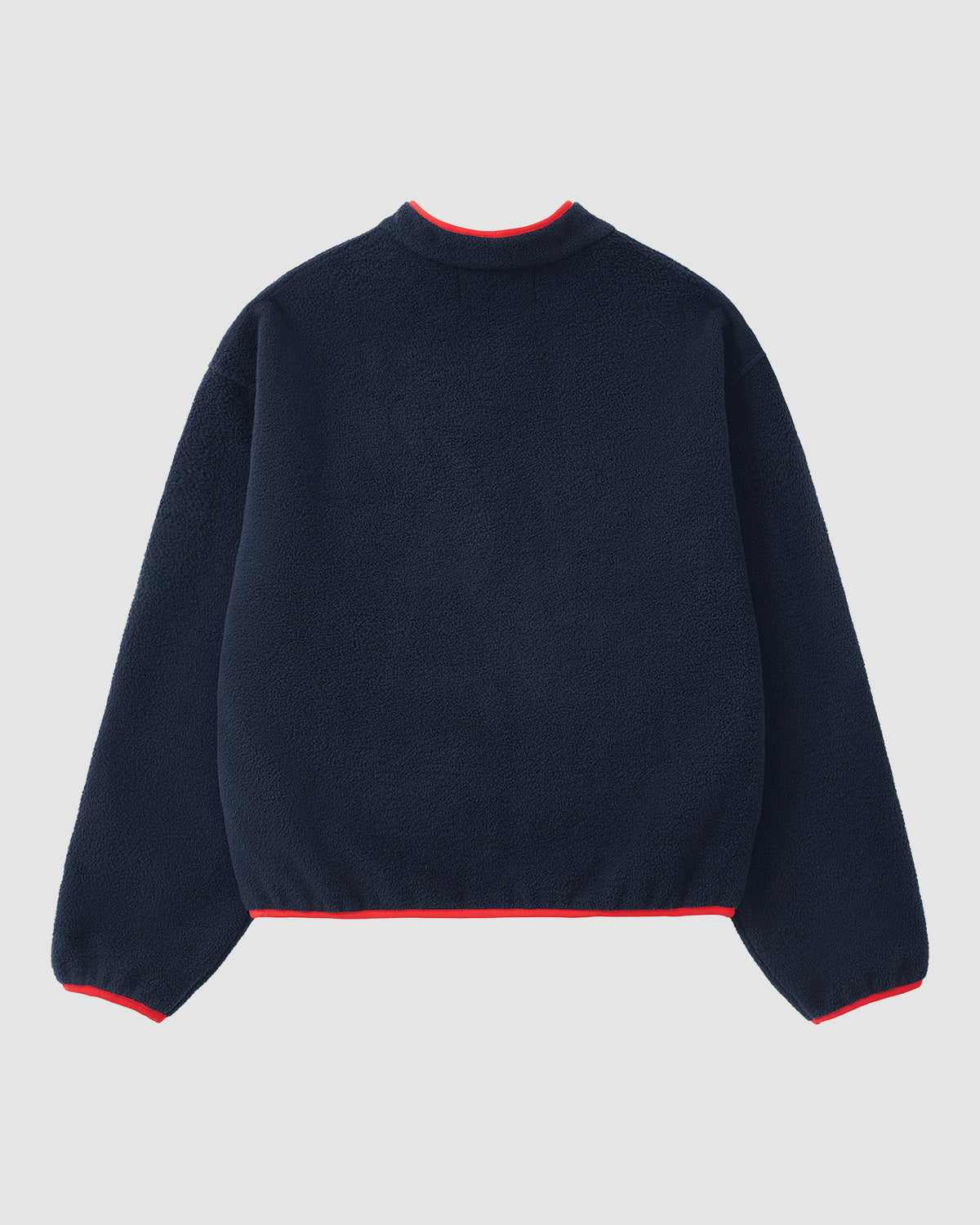 The NAVY TEARDROP KNOT FLEECE by Sundae School is shown from the back, displaying long sleeves and subtle red trim on the collar, cuffs, and hem against a plain light background.