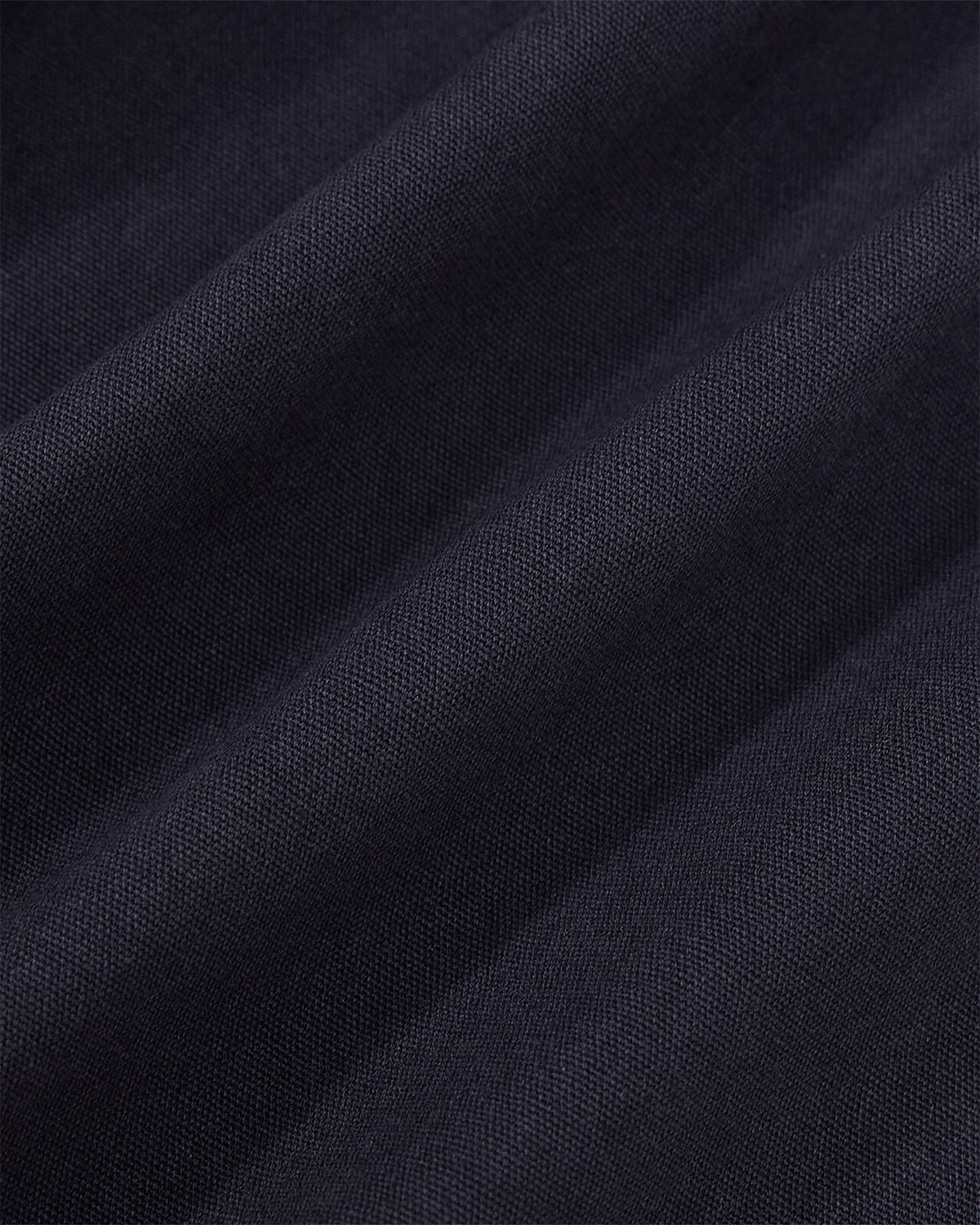 Close-up texture detail of the navy linen fabric of the Hanbok Balloon Pants showing the weave pattern.