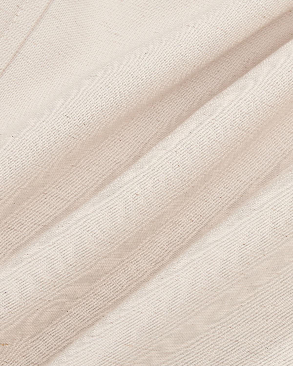Close-up detail of cream hanbok shirt fabric showing soft drape and textured weave of rayon-linen blend material
