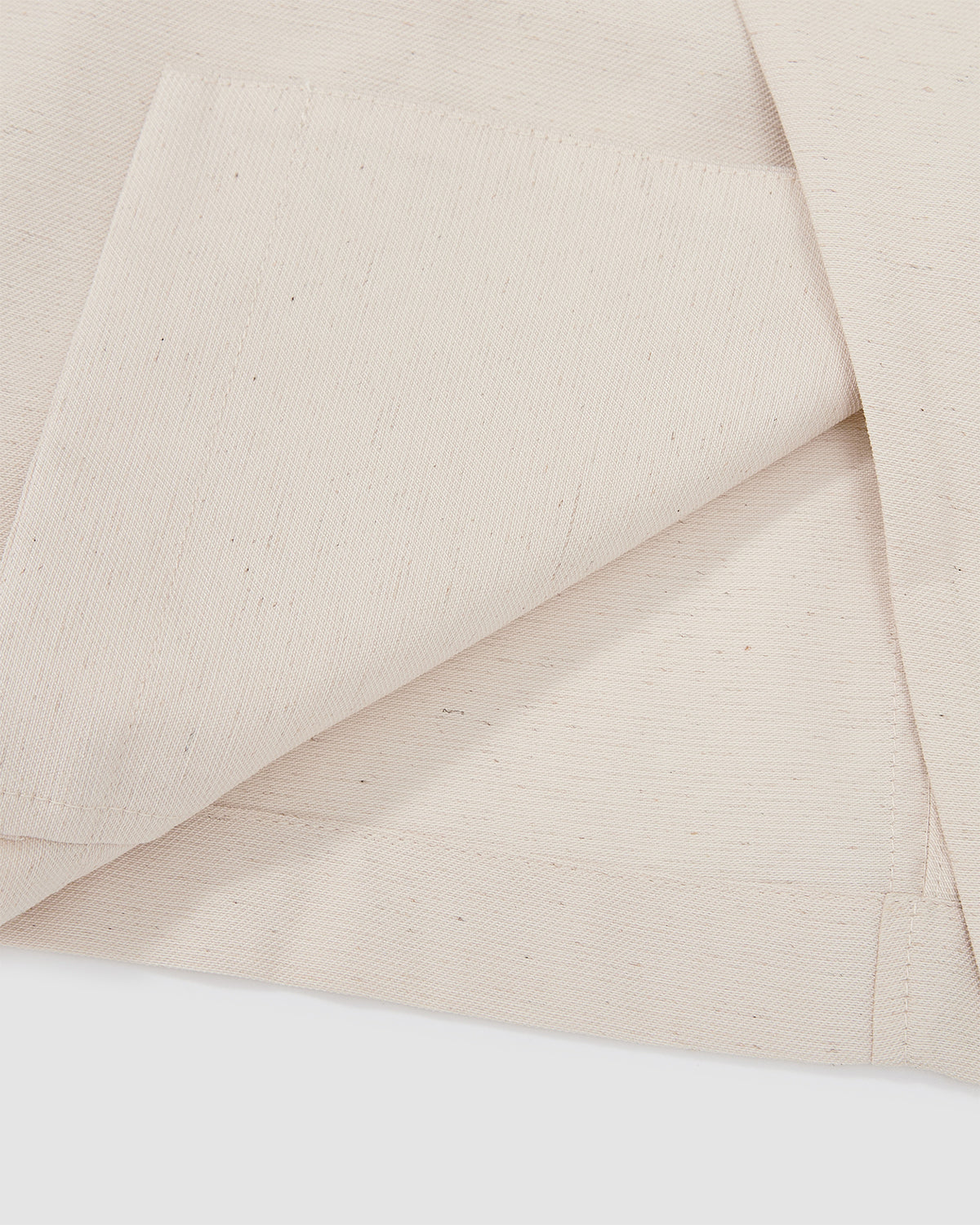 Close-up detail of cream hanbok shirt showing asymmetric front panel construction and clean finishing on lightweight linen blend fabric