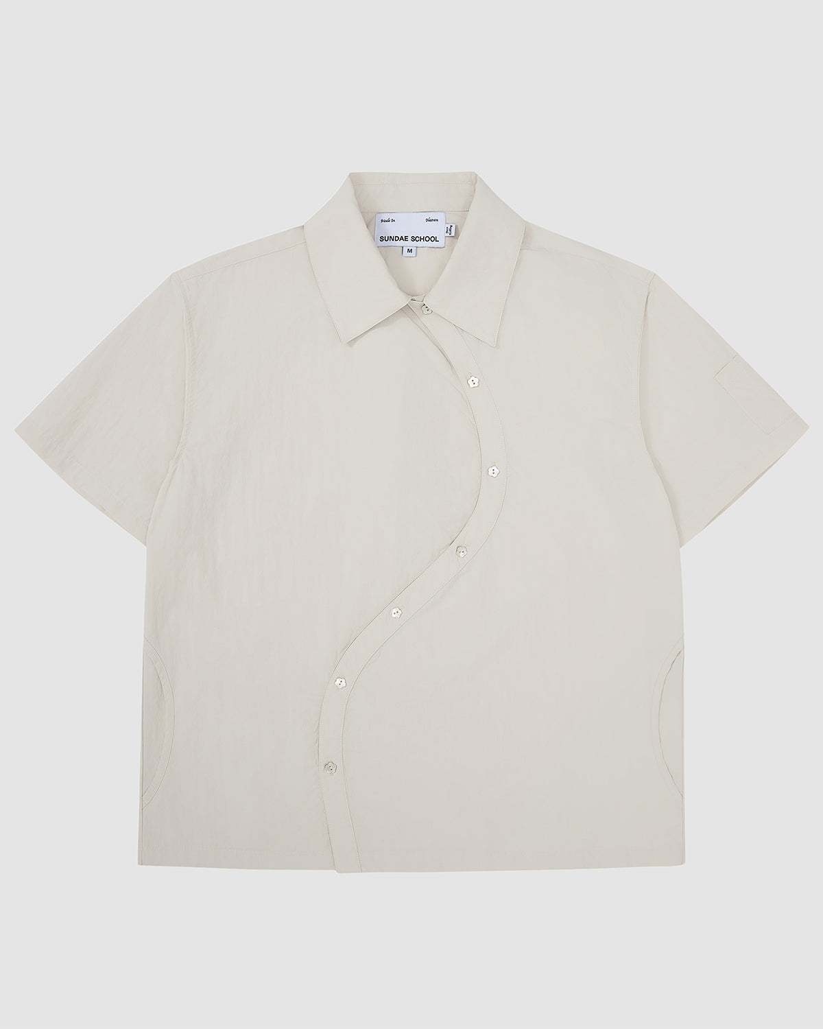 Off-white Ivory Yin Yang Short Sleeve Shirt with asymmetrical curved button placket, classic collar, and short sleeves.