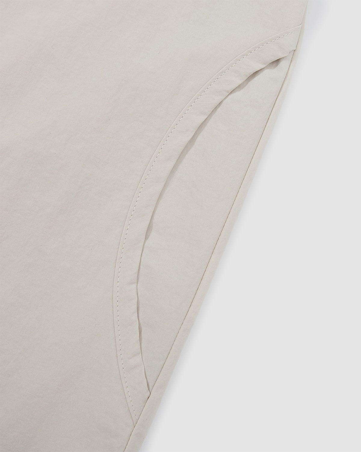 Detail of the curved button placket construction on the Ivory Yin Yang Short Sleeve Shirt showing the yin-yang inspired design.