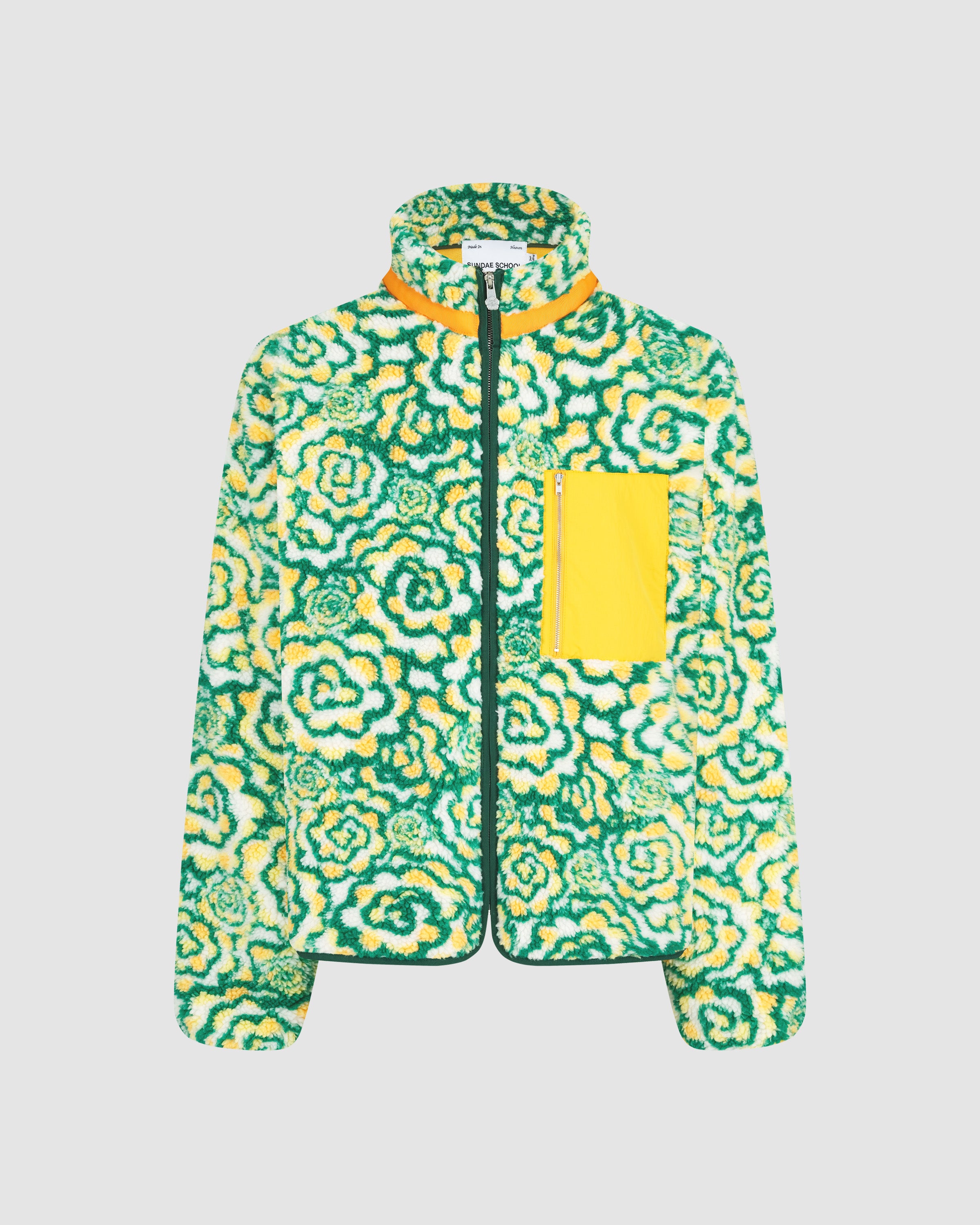 Sundae School Broccoli fleece jacket featuring green and yellow floral patterned fleece, orange contrast collar and trim details, dark green zip closure, yellow chest pocket with zipper, relaxed fit silhouette, flat lay product shot on light background.