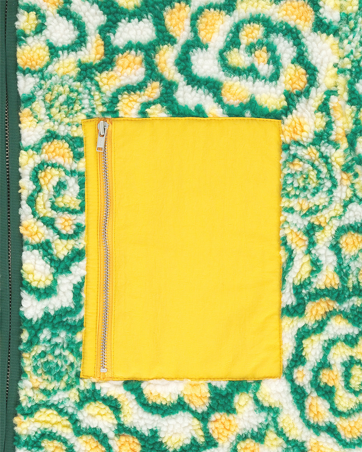Detail shot of the Sundae School Broccoli fleece jacket featuring green and yellow floral patterned fleece's yellow chest, flat lay product shot on light background.