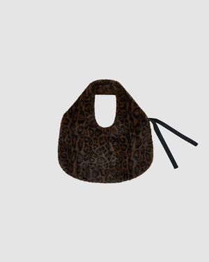 The BLACK LEOPARD BAEJA VEST / BAG by Sundae School is a brown faux fur bag with a black leopard print, short handle, and black ribbon ties, styled to complement your reversible vest or Korean baeja look—shown on a light gray background.