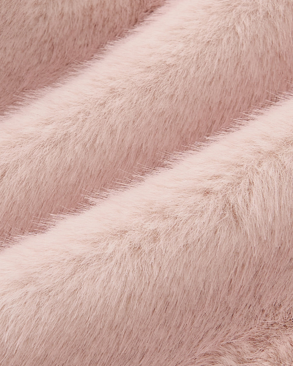 Close-up of soft, fluffy, light pink faux fur fabric with gentle waves and a plush texture, featured in the SILVER PINK BAEJA VEST / BAG by Sundae School, inspired by traditional Korean vests.