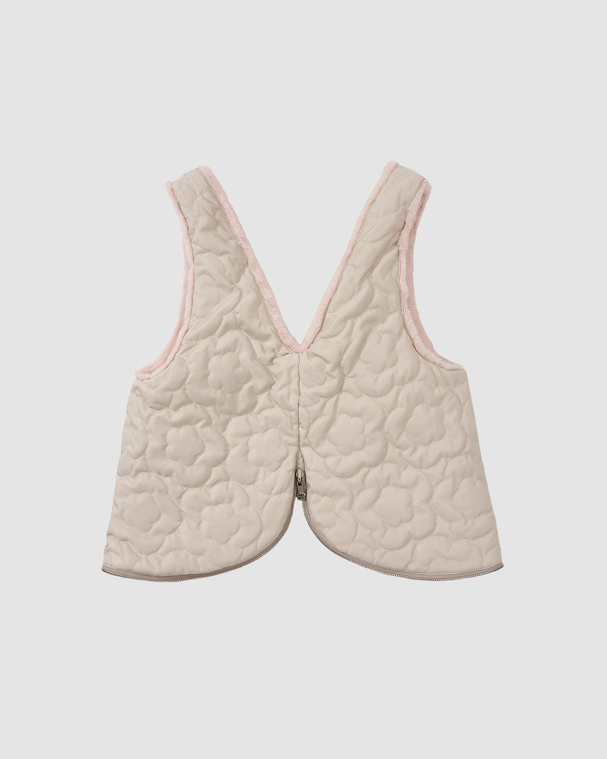 The Sundae School SILVER PINK BAEJA VEST / BAG is a sleeveless, quilted beige reversible vest with a floral print, light pink trim, V-neckline, and slightly curved hem, shown against a plain white background.