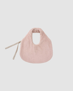 The SILVER PINK BAEJA VEST / BAG by Sundae School features a soft, light pink hue and rounded shape with beige tie straps, evoking the timeless elegance of a traditional Korean vest, shown against a plain white background.