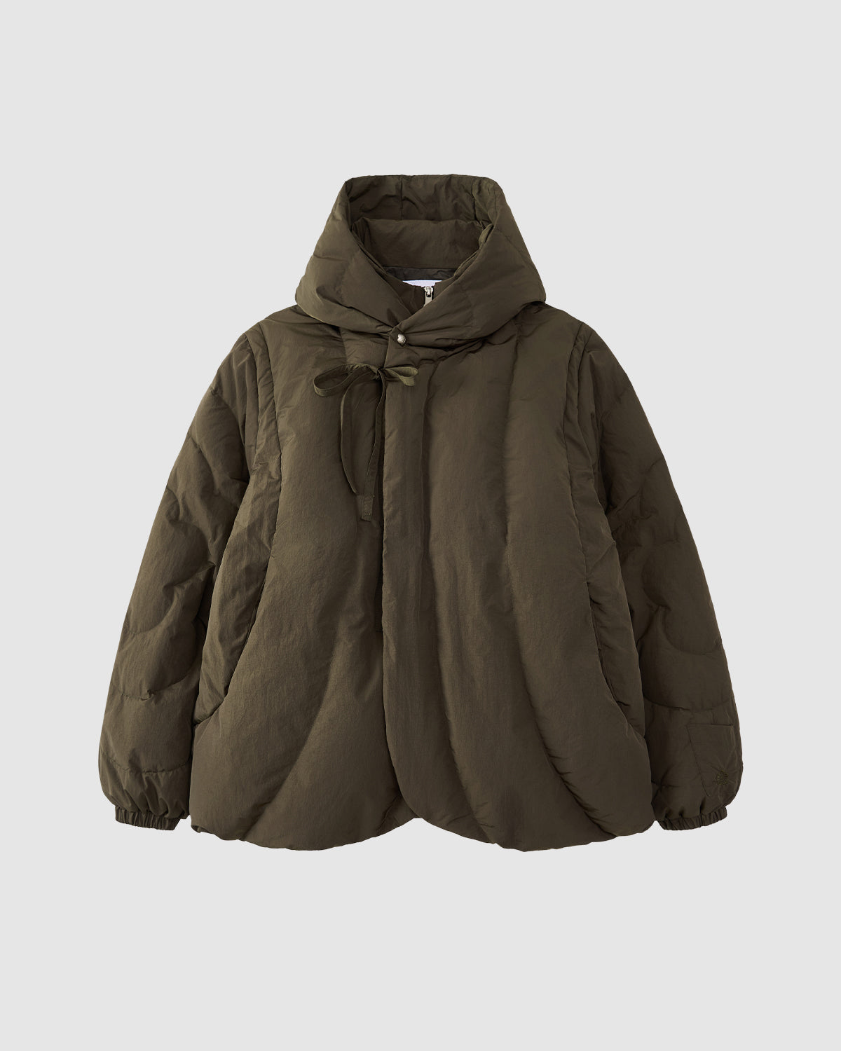 The Sundae School KHAKI HEAVYWEIGHT MOCHI PUFFER is a Korean hanbok-inspired olive green hooded jacket with quilted stitching, front bow tie closure, and elasticated cuffs, shown against a plain light gray background.