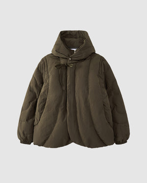 The Sundae School KHAKI HEAVYWEIGHT MOCHI PUFFER is a Korean hanbok-inspired olive green hooded jacket with quilted stitching, front bow tie closure, and elasticated cuffs, shown against a plain light gray background.