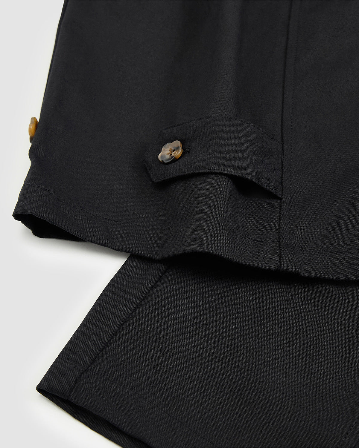 Close-up of the adjustable button tab at the hem of the Hanbok Balloon Pants with flower-shaped button.