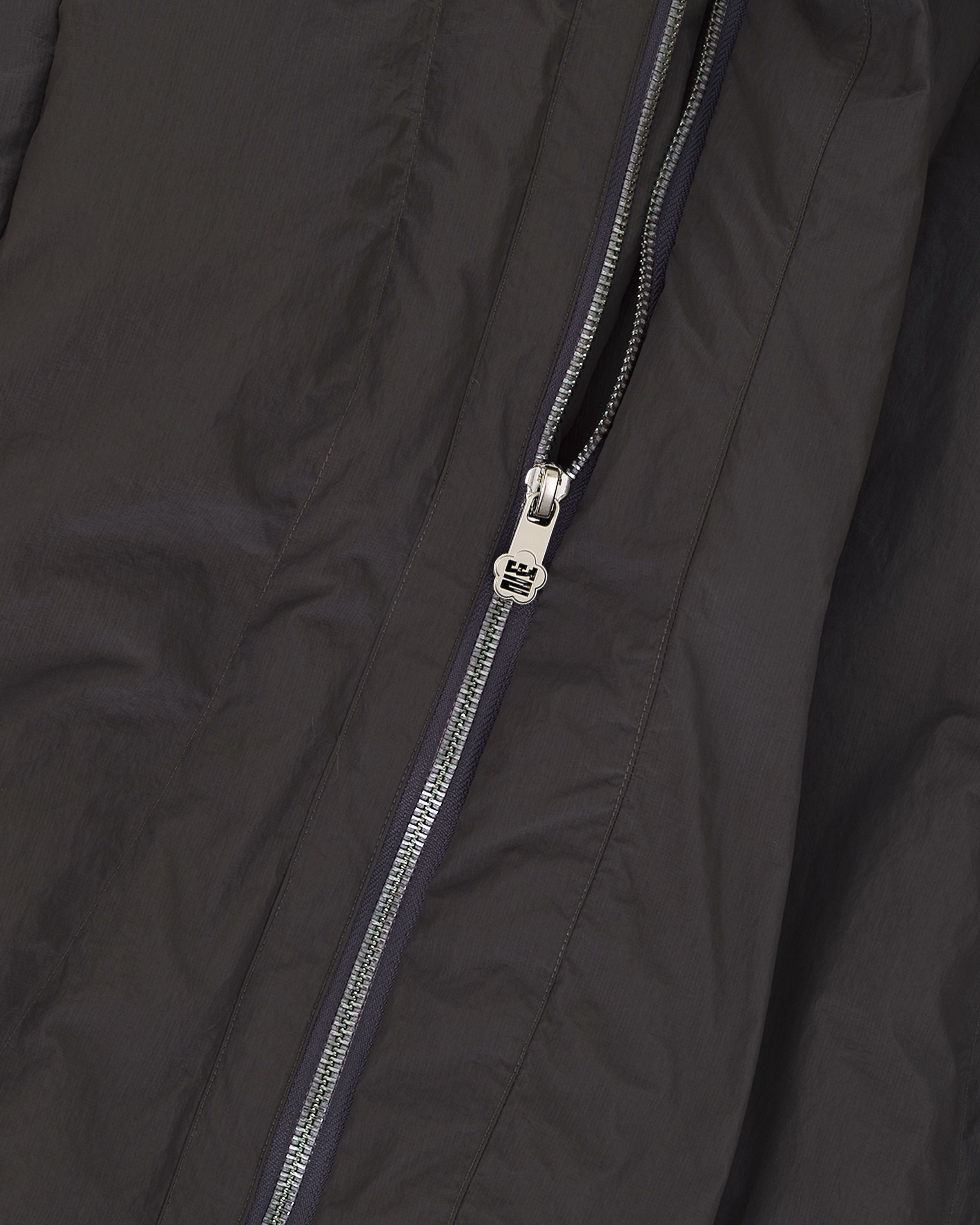 Close-up of the Sundae School CHARCOAL HEAVYWEIGHT MOCHI PUFFER, showcasing its rich fabric texture and detailed silver zipper partially unzipped.