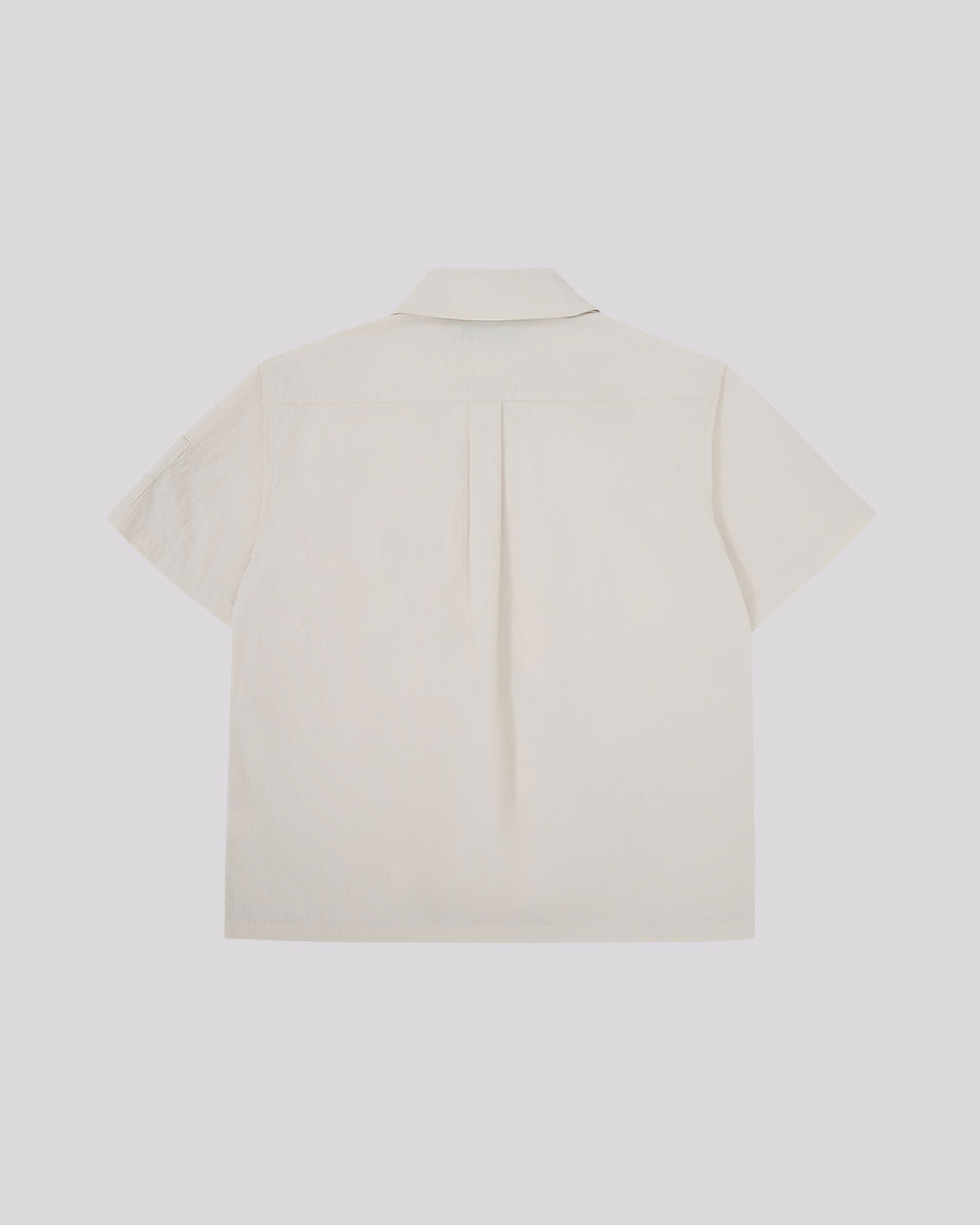 Back view of the off-white Ivory Yin Yang Short Sleeve Shirt showing the clean, minimalist design with center back pleat.