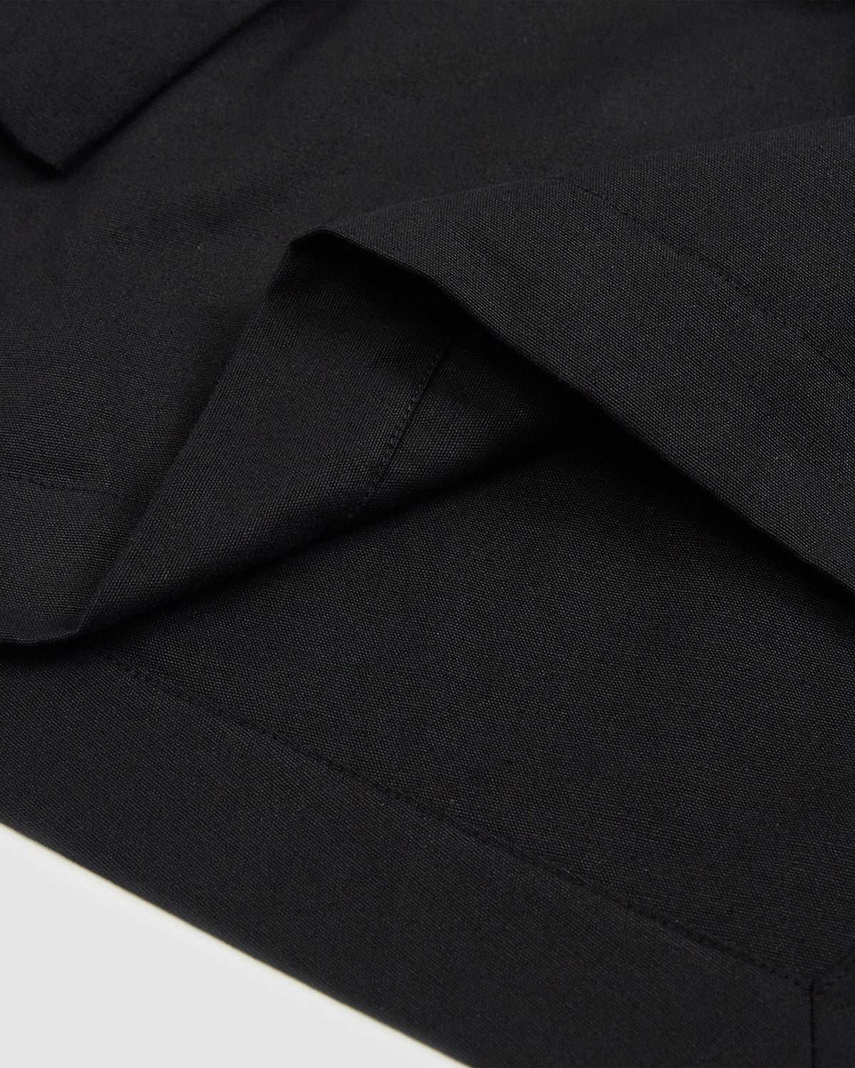 Detail view of the asymmetrical front overlap of the Hanbok Tie Blazer