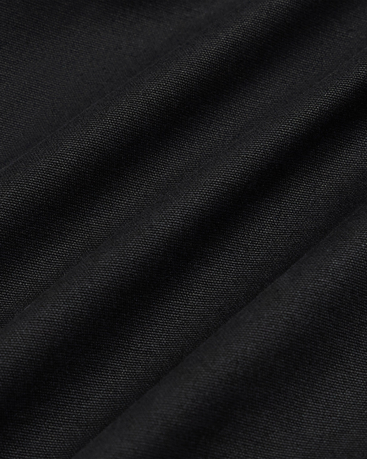 Close-up detail of the Black fabric texture of the Hanbok Tie Blazer.