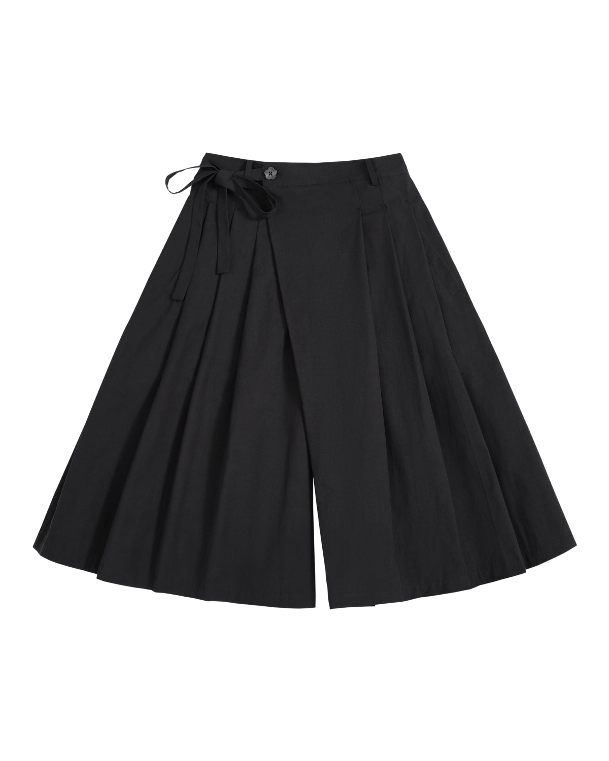The ASYMMETRIC CHIMA CULOTTE by Sundae School, featuring black wide-leg pleated pants with a buttoned waist and a tied ribbon detail on one side, evokes the flowing elegance of a hanbok chima and is displayed laid flat on a white background.