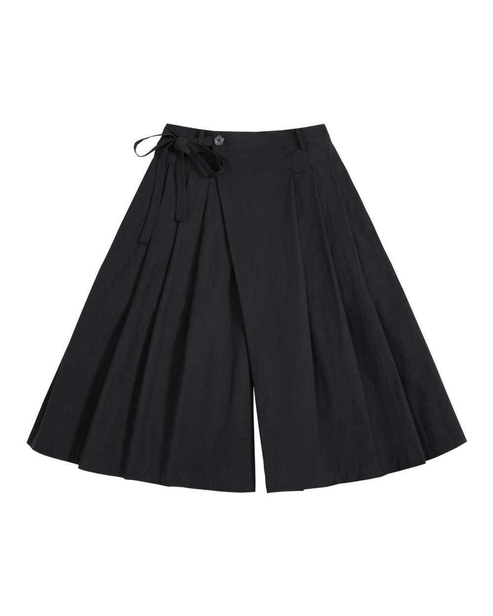 The ASYMMETRIC CHIMA CULOTTE by Sundae School, featuring black wide-leg pleated pants with a buttoned waist and a tied ribbon detail on one side, evokes the flowing elegance of a hanbok chima and is displayed laid flat on a white background.