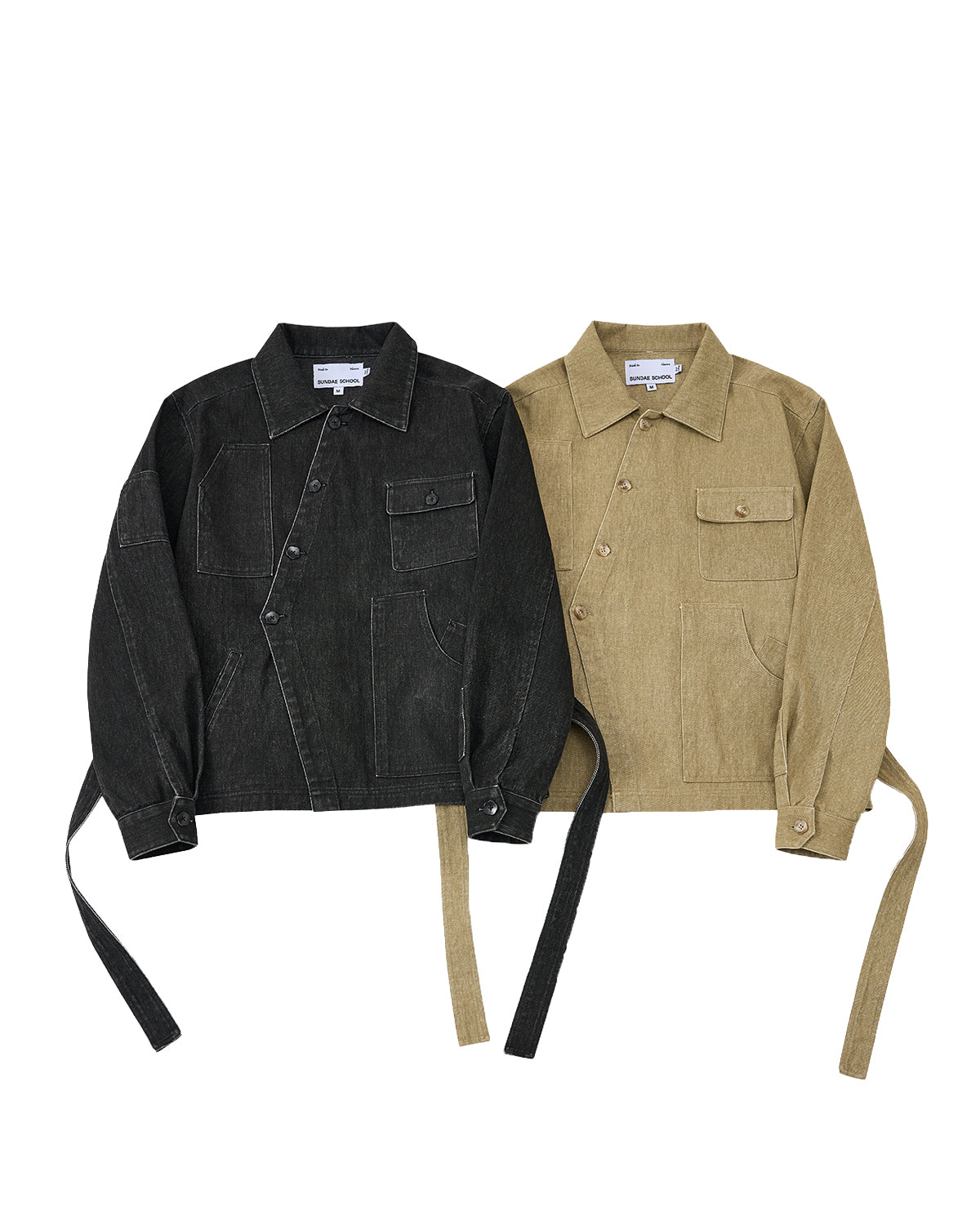 Two Sundae School TAN ASYMMETRIC WORK JACKETS, one in black and one in tan, each with seven pockets and long side straps, are laid flat on a white background.