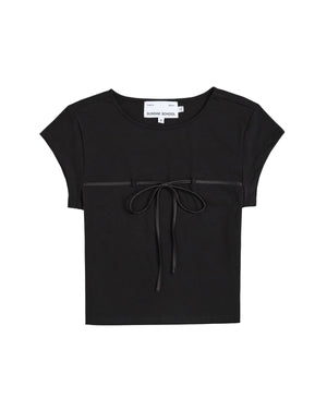 Introducing the BLACK TIE GORUM BABY TEE by Sundae School—a black cotton jersey crop top featuring short sleeves, a round neckline, and an eye-catching decorative bow at the front. Displayed flat against a white background, this form-fitting women’s shirt offers both comfort and modern style with its relaxed cropped baby tee silhouette.
