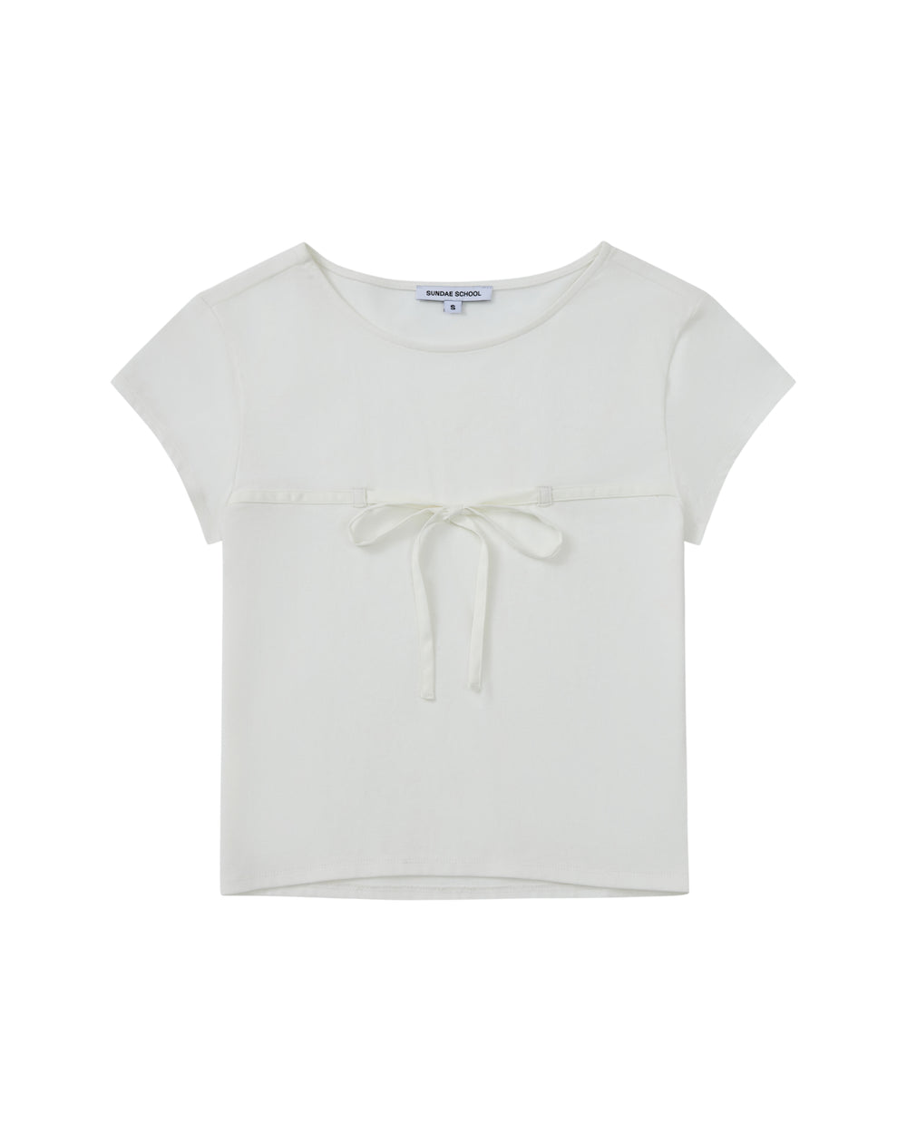 The WHITE TIE GORUM BABY TEE by Sundae School is a short-sleeved, white cropped baby tee featuring a scooped neckline and a chest strap bow detail, displayed laid flat against a white background.
