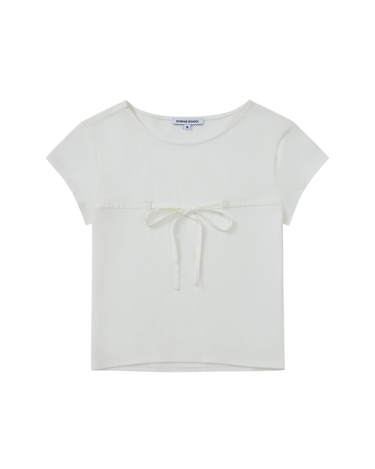 The WHITE TIE GORUM BABY TEE by Sundae School is a short-sleeved, white cropped baby tee featuring a scooped neckline and a chest strap bow detail, displayed laid flat against a white background.