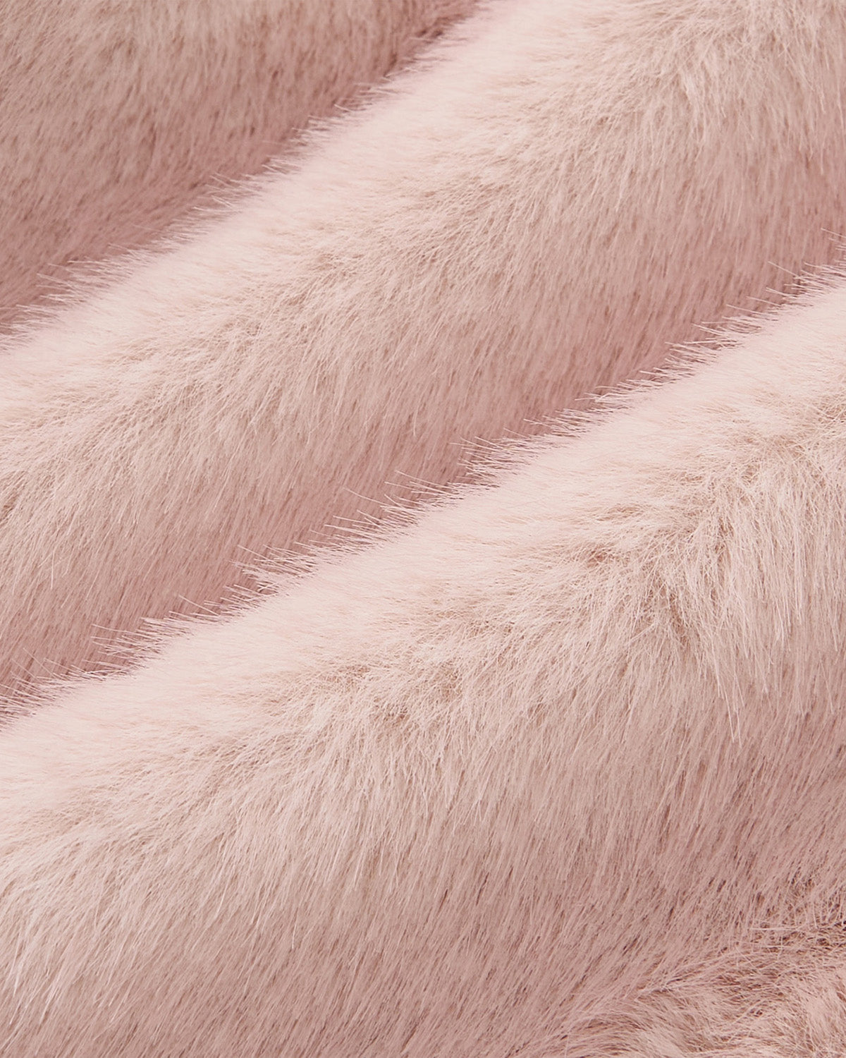Close-up of soft, fluffy pale pink fabric with a fur-like texture, featuring wavy ridges and fine hair strands—ideal for creating the Sundae School SILVER PINK BAEJA VEST or a chic faux fur bag.