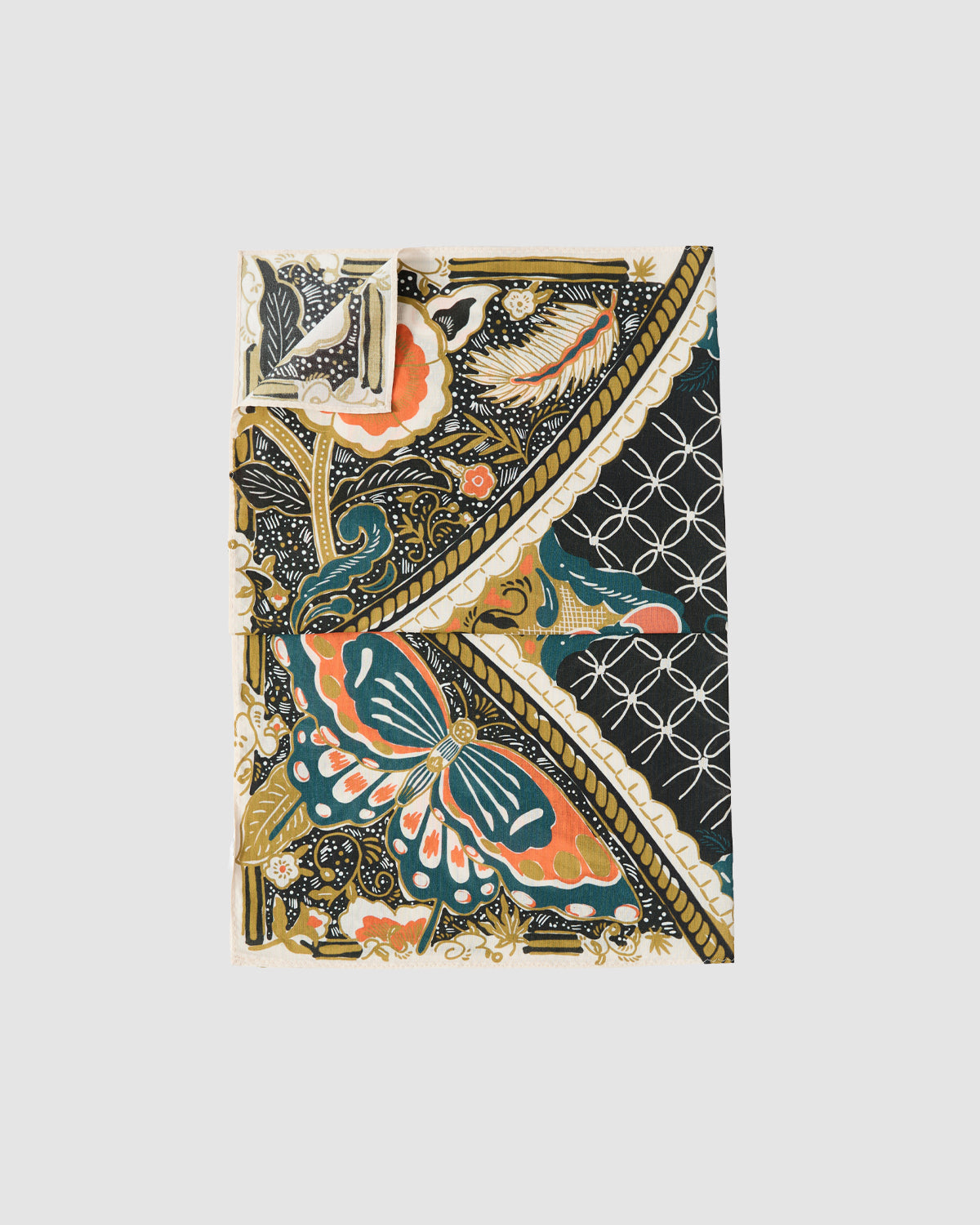 The Sundae School MULTI-COLOR BATIK BANDANA features intricate Indonesian batik-inspired floral, butterfly, and geometric motifs in orange, teal, gold, and black.