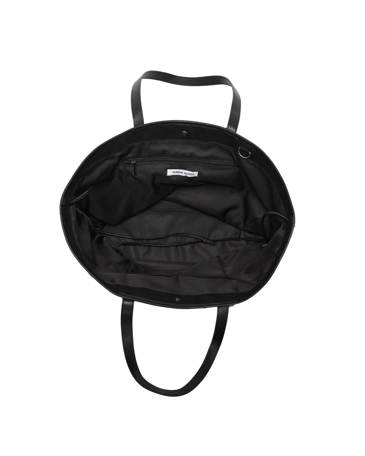 Interior view of a black Sundae School BLACK BOJAGI TIE TOTE BAG showing a zippered pocket and a brand tag.