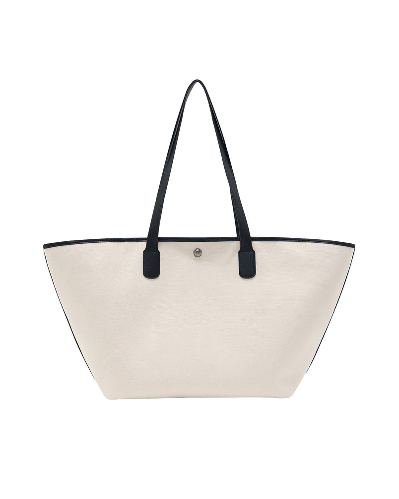The IVORY BOJAGI TIE TOTE BAG by Sundae School, featuring black vegan leather trim and handles, is displayed upright against a plain white background.