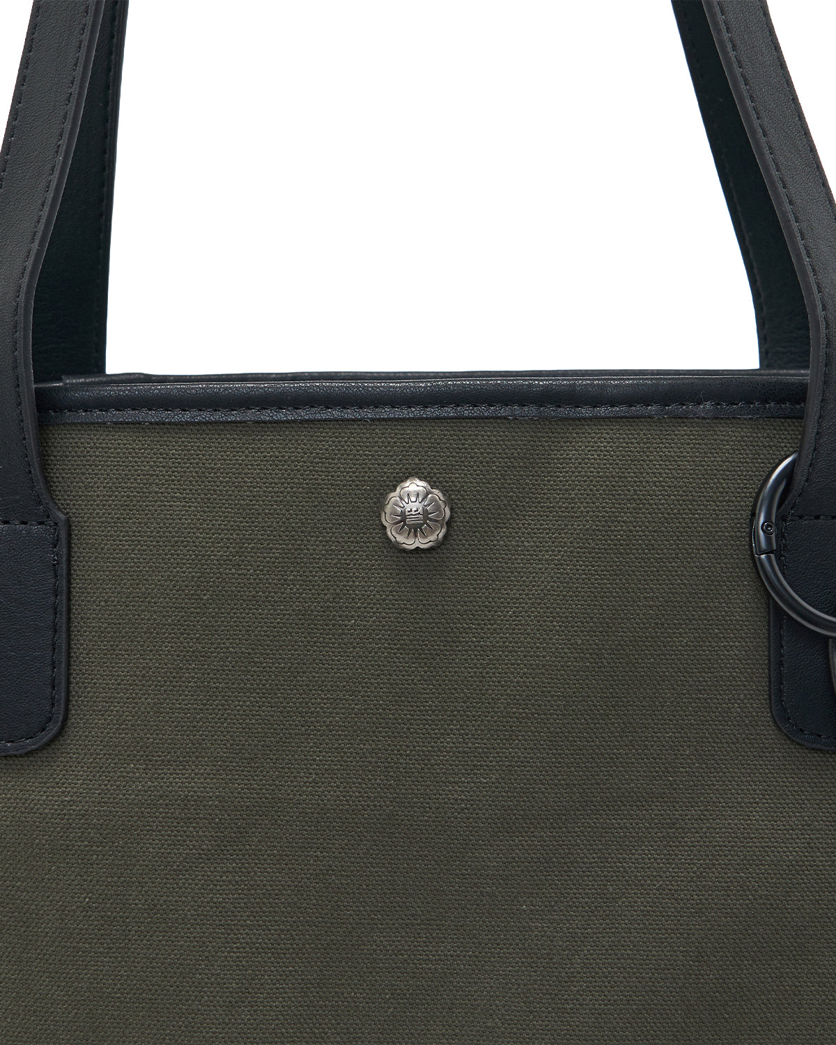 Close-up of the Sundae School OLIVE BOJAGI TIE TOTE BAG, crafted from olive green cotton canvas with black vegan leather straps and trim, and featuring a small silver lion head emblem at the center.
