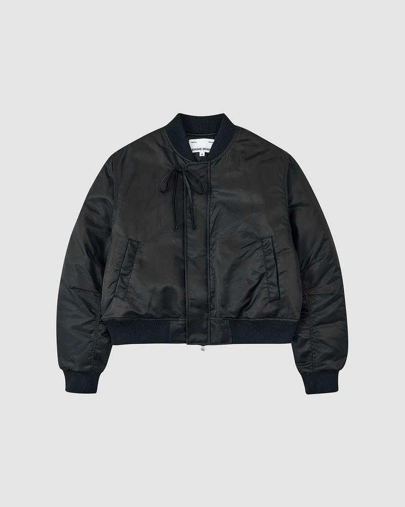 A flatshot of Sundae School Black Flower Channeled Bomber against a white background.