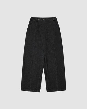 Black wide-leg hanbok denim pants with high-rise waist and asymmetric front closure featuring silver flower-shaped snap buttons, relaxed fit silhouette, flat lay photography on light gray background