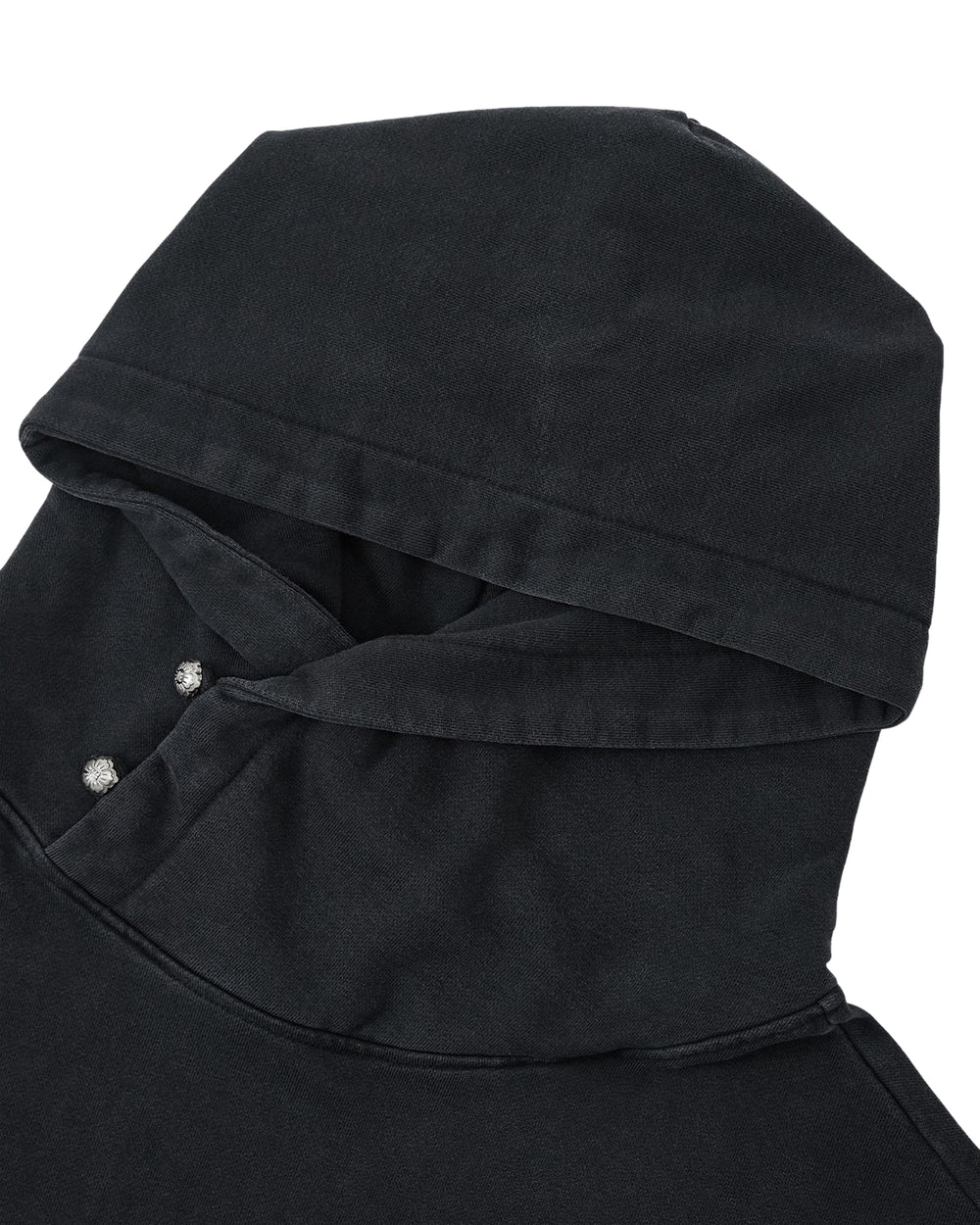 Close-up of the Sundae School FADE BLACK COCOON HOODIE laid flat, highlighting its oversized hood and shoulder with two visible metal snaps near the neck. The subtle winged silhouette adds a modern twist to this classic black sweatshirt.