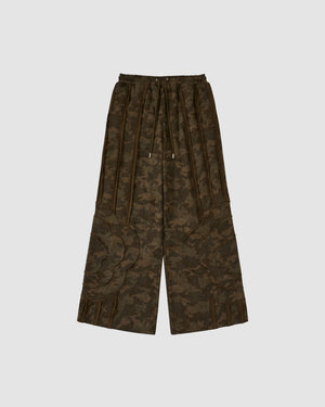The Sundae School CAMO MOCHI HAZE PANELED SWEATPANTS feature wide-leg 100% cotton, an elastic waistband with drawstring, large patch pockets, a dark green and brown camo print, and decorative leg seam details.