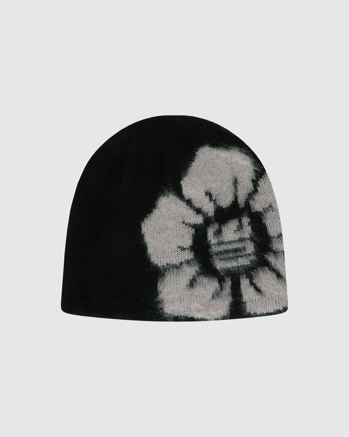 The Black Ddul Beanie by Sundae School is a black acrylic hat featuring a bold, light gray flower on one side, set against a plain light gray background. This stylish beanie blends fashion and comfort in protective headwear.