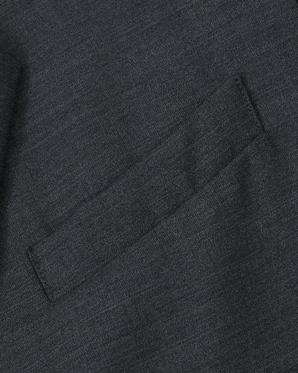 Close-up of the CHARCOAL DOUBLE DUTY BLAZER by Sundae School, featuring a small, angled welt pocket expertly stitched into the dark gray premium wool-blend fabric. The material’s refined texture highlights careful craftsmanship and an elevated hanbok-inspired silhouette.