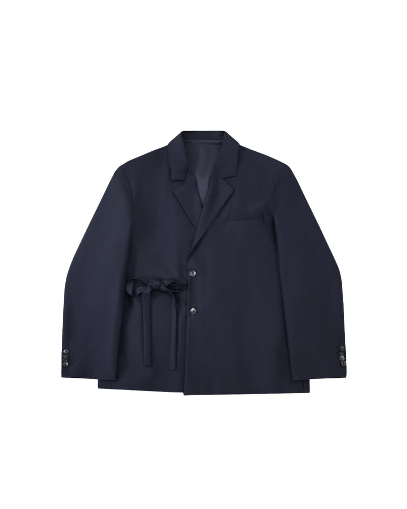 The Sundae School NAVY DOUBLE DUTY BLAZER, a navy wool blend with notched lapel, front buttons, chest pocket, and hanbok-inspired fabric belt at the waist, is displayed flat on a light gray background.