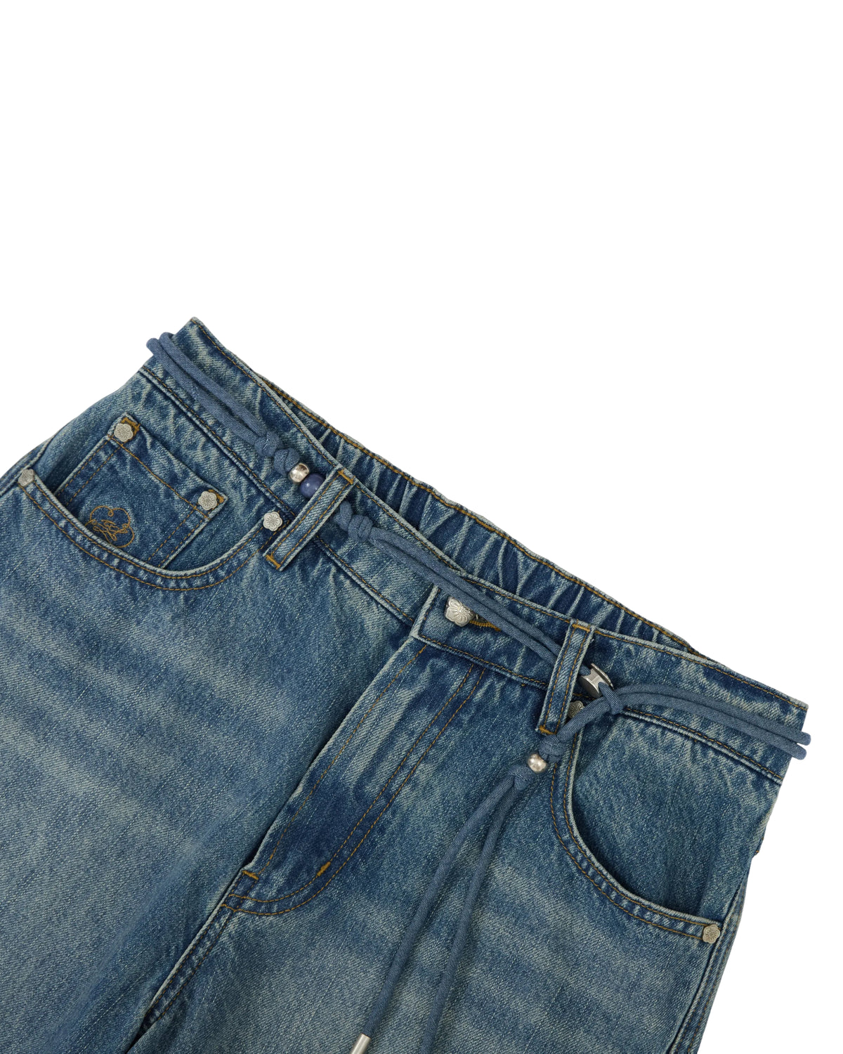 Close-up of the Sundae School MEDIUM BLUE FRESHMAN FIT DENIM, featuring an elastic waistband, front pockets, belt loops, and a visible drawstring. Inspired by the relaxed silhouette of boyfriend fit jeans, this pair highlights subtle hanbok denim influences against a clean white background.