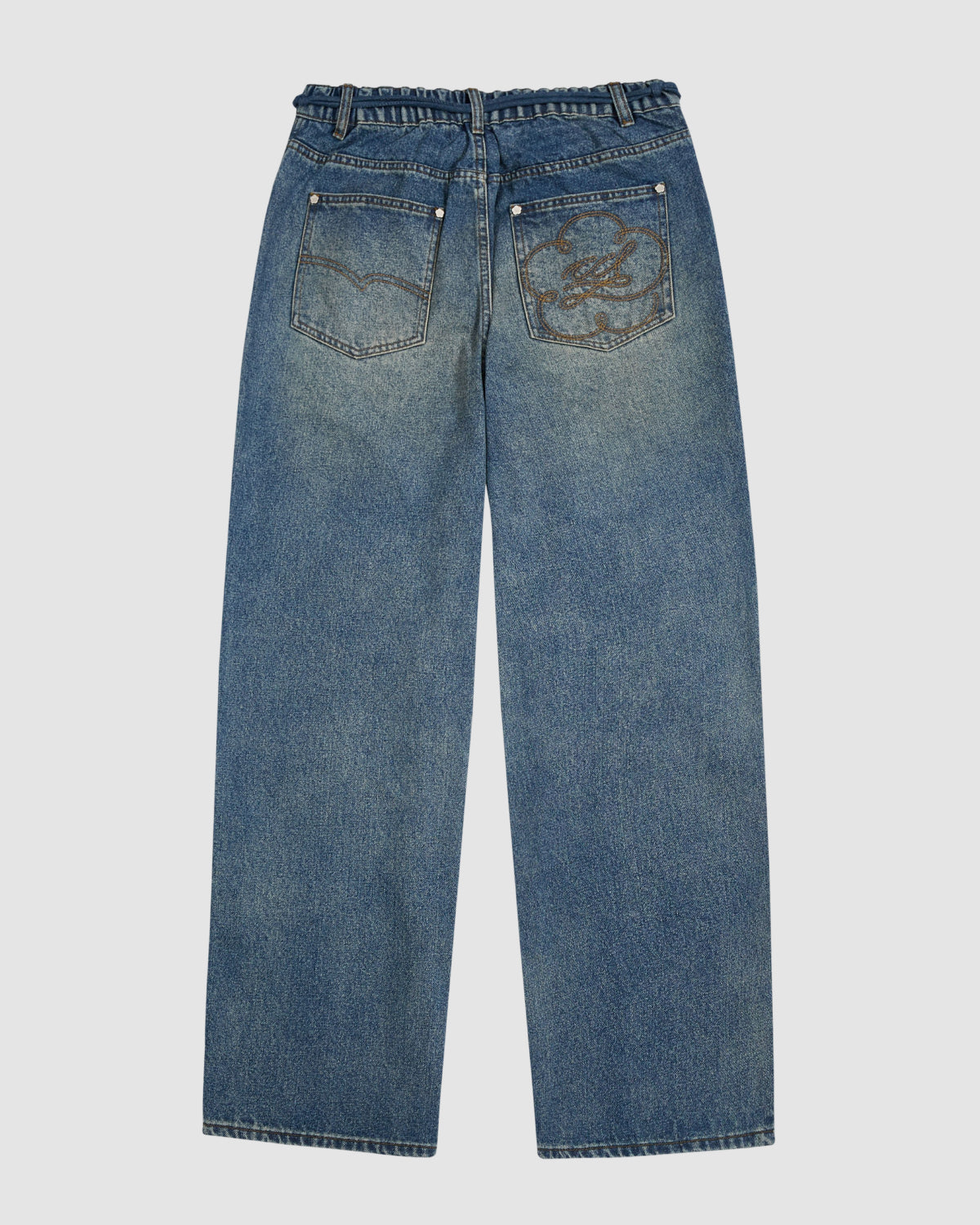 Sundae School’s MEDIUM BLUE FRESHMAN FIT DENIM features relaxed straight legs, two back pockets—including a right pocket with a faded circular patch—and a slightly worn blue wash for a casual, timeless look.