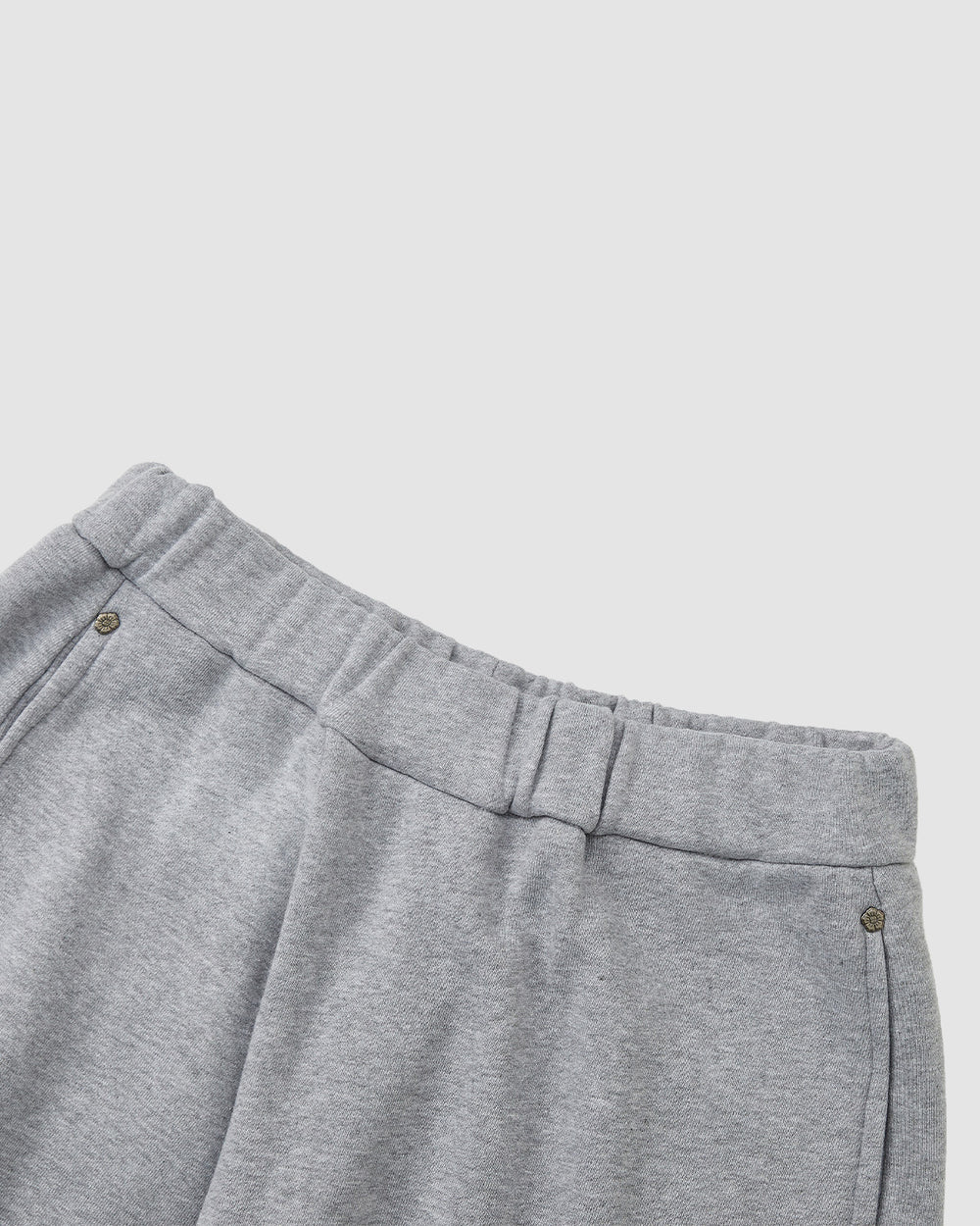 HEATHER GREY WRAP SWEATBAJI by Sundae School—unisex cotton pants in heather grey, featuring an elastic waistband and side pockets, displayed waist-down against a plain light background.