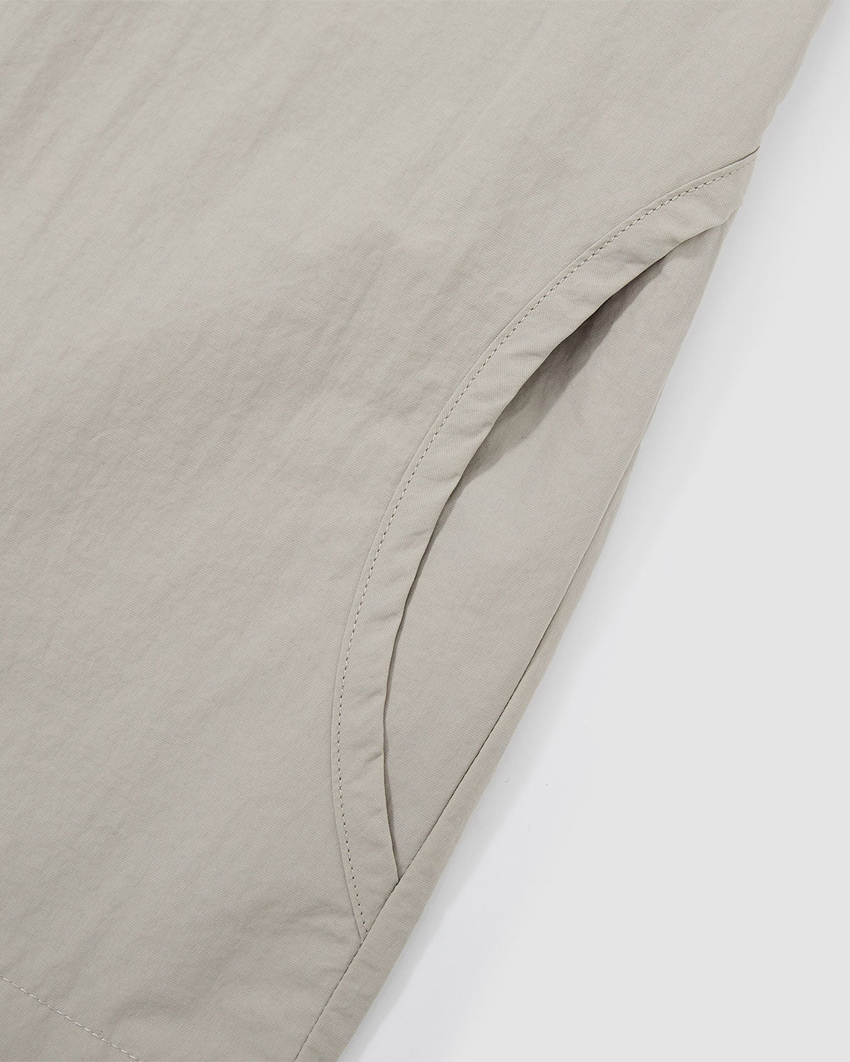 Detail of the curved button placket construction on the Gray Yin Yang Short Sleeve Shirt showing the yin-yang inspired design.