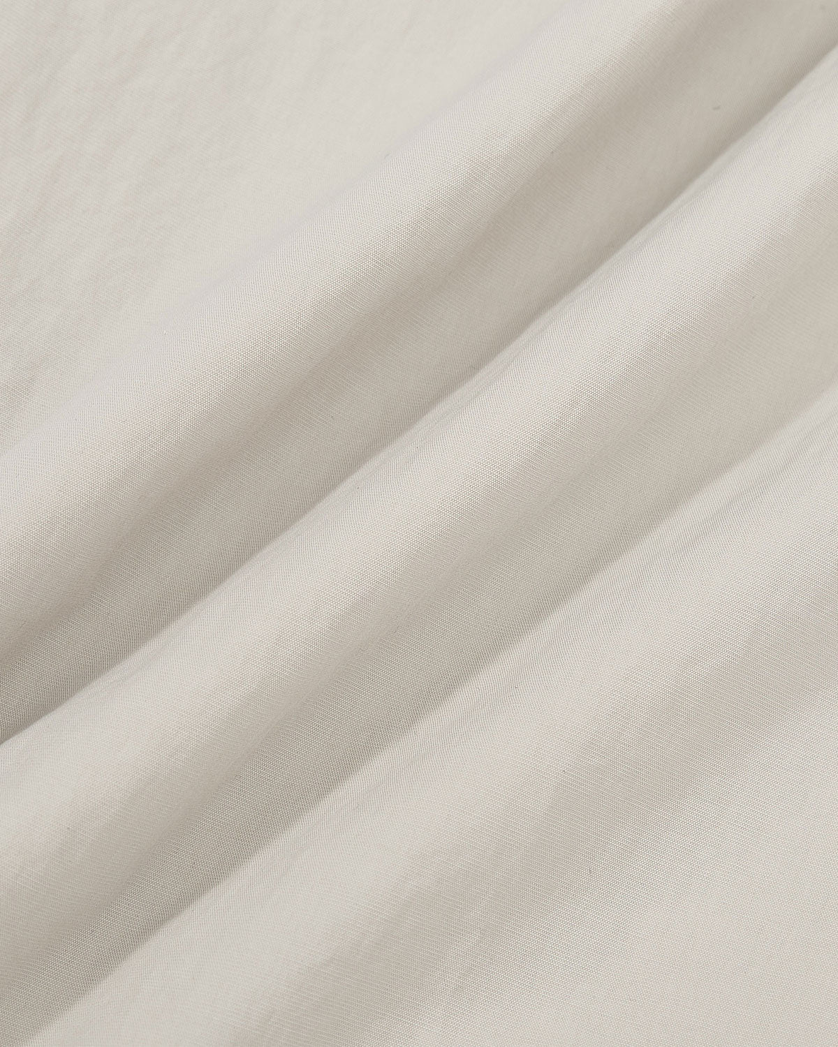 Close-up texture detail of the light gray fabric of the Gray Yin Yang Short Sleeve Shirt showing the smooth cotton-nylon blend material.
