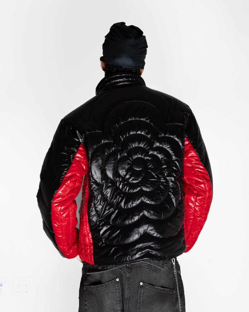 The back of the model wearing Sundae School Black Red Mochi Spiral Puffer