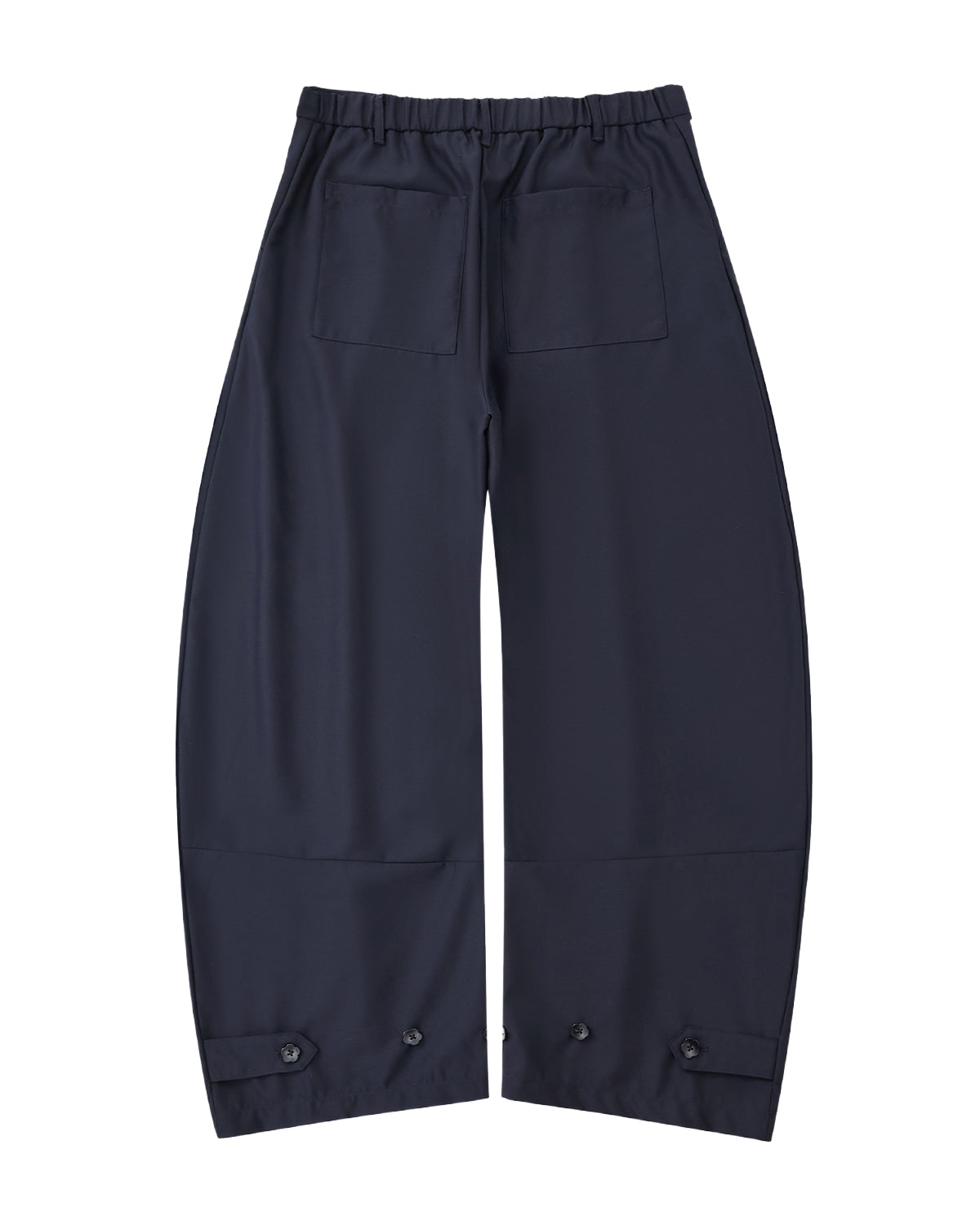 Sundae School NAVY PLEATED HANBOK SLACKS featuring an elastic waistband, two back pockets, and adjustable button cuffs, shown flat on a white background.