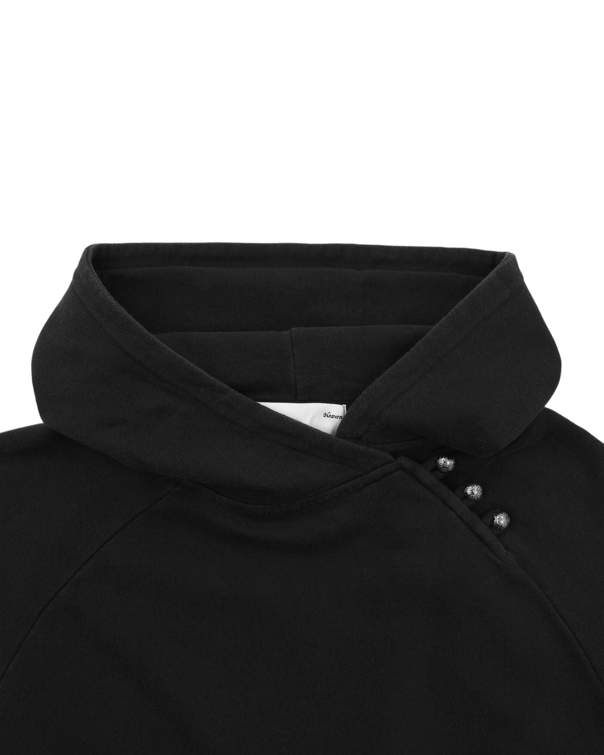 Close-up of the BLACK WASH HANBOK HOODIE by Sundae School, a black cotton sweatshirt featuring a high collar with four metallic buttons along one side near the neckline, inspired by traditional Hanbok elements and finished with an oversized hood for a contemporary update.
