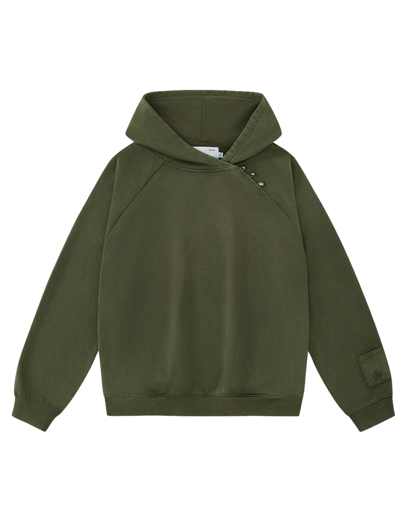 The KHAKI HANBOK HOODIE by Sundae School is an olive green hooded sweatshirt with long sleeves, featuring an asymmetric hood closure with snap buttons on the right shoulder and a patch on the left sleeve. This custom “떨” logo hoodie also includes a signature sleeve stash pocket, and is shown laid flat on a white background.